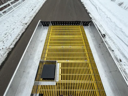 Upper deck with yellow grating and mounted side compartment lids.